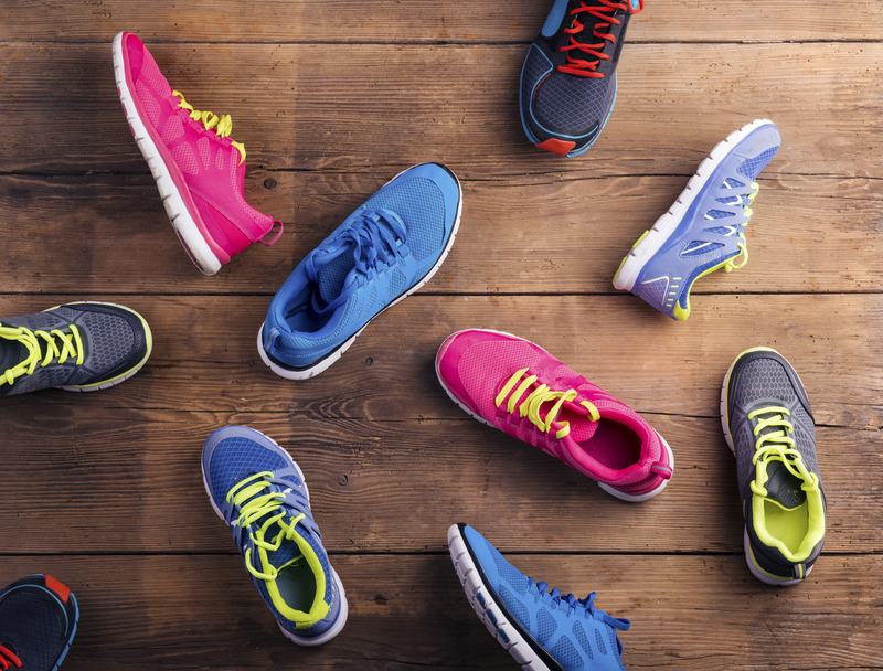 Various colorful running shoes scattered on the floor.