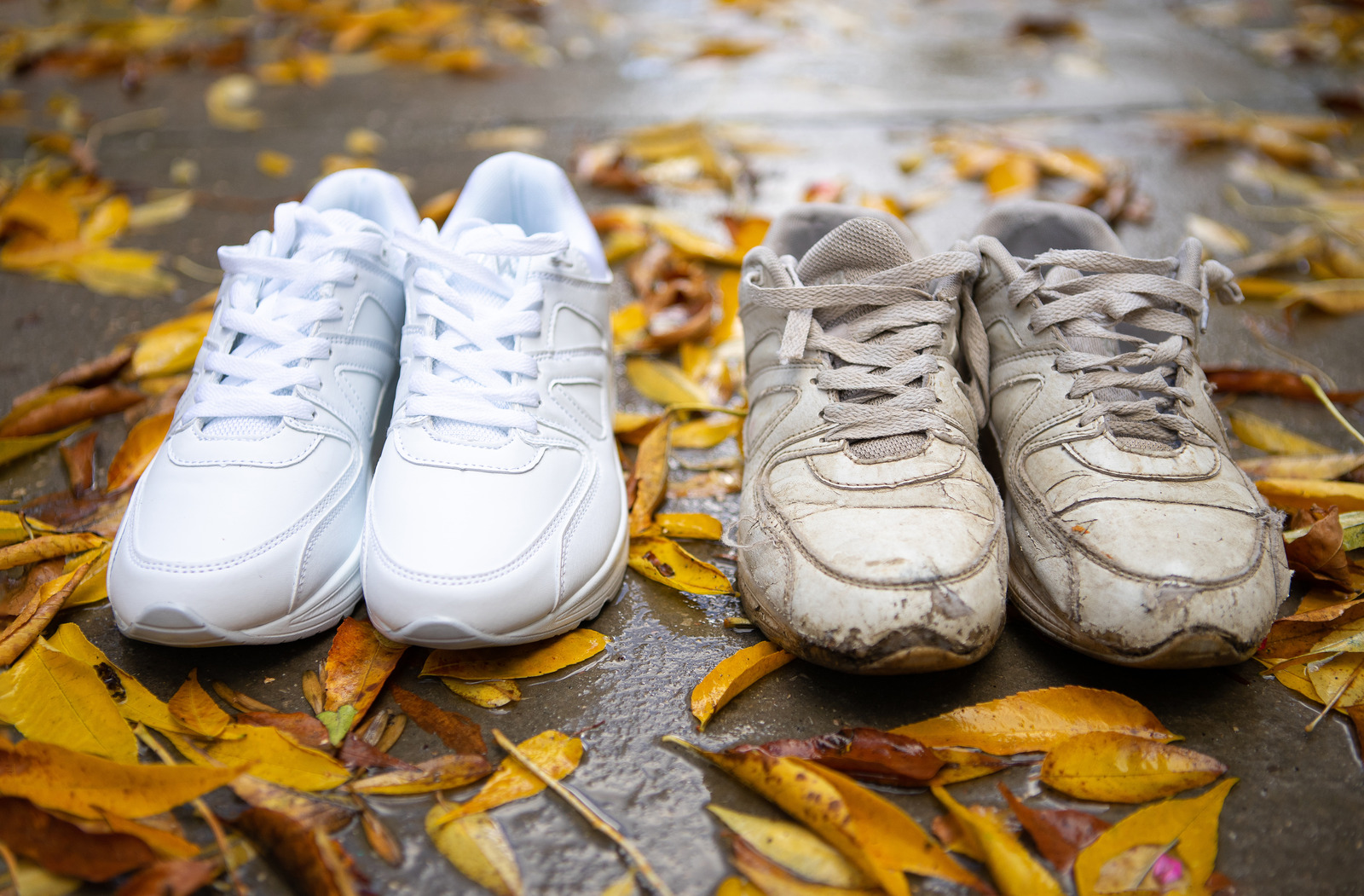 A pair of new and used running shoes side-by-side.